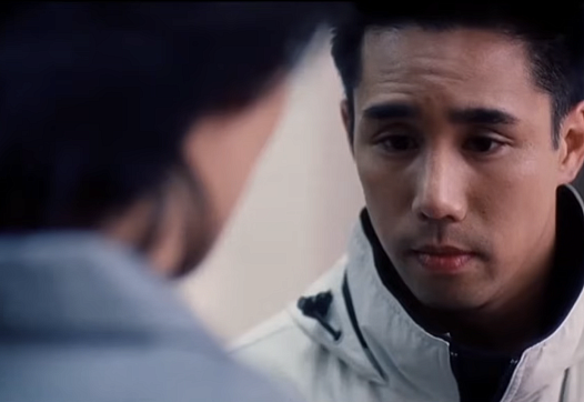 A tight shot from the film Better Luck Next Time shows two Korean high school students talking