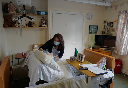 A nurse checking on a patient