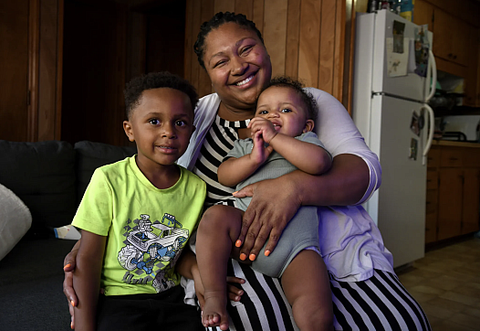 Person holding 2 children