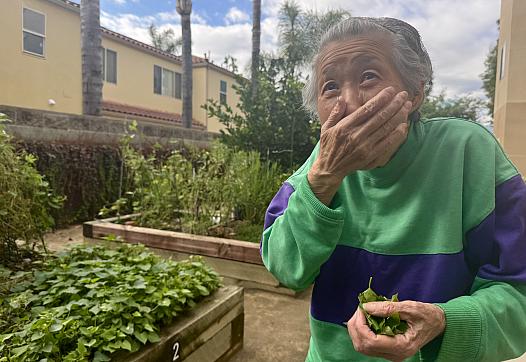 a woman with her hand to her mouth