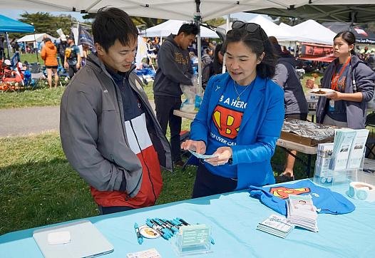 Two people at health camp interacting with one another