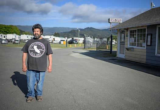 Person standing in front of the entrance to a trailer park 