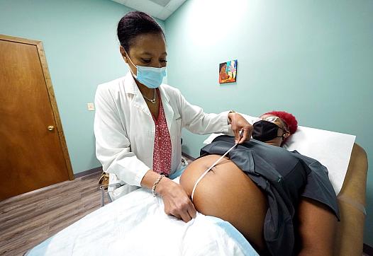 A midwife at Sisters in Birth — a clinic that serves pregnant women in Jackson, Mississippi — conducts an examination.
