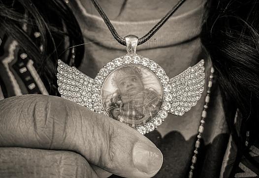 Image of a person showing their pendant