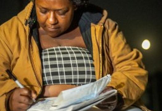 Person writing in a book