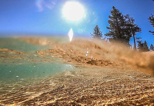 Water laps at the lake Tahoe's beach shore