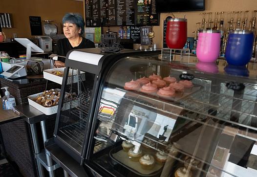 Person standing behind a bakery counter