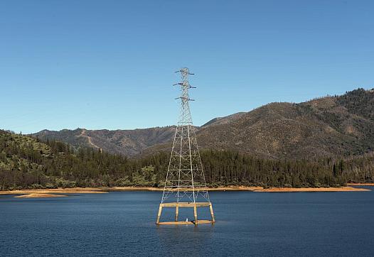 electric tower in the middle of a water body
