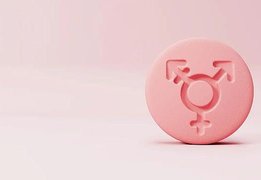 Pink pill with gender symbols on it