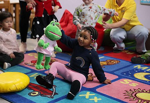 A child playing with a soft toy