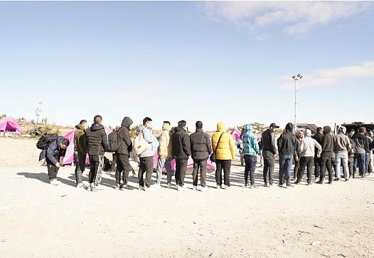 Image of people standing in a queue