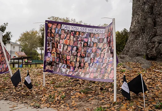a board standing by a tree 