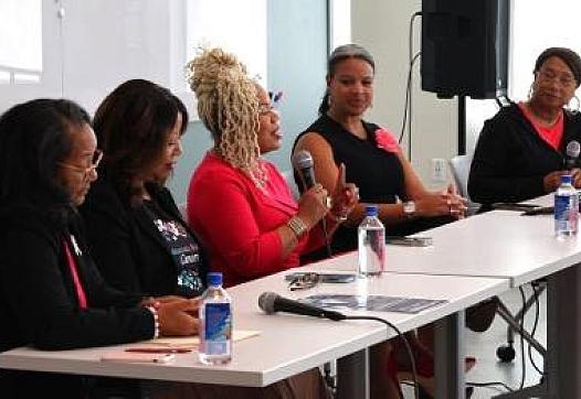 People at a table, with a person talking on a mic
