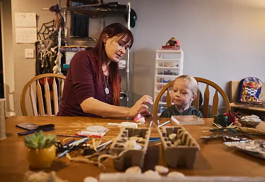 A person and a child at a table