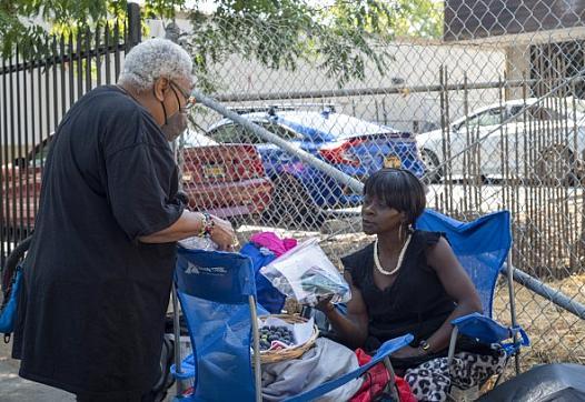 Person distributing hygiene supplies to another person