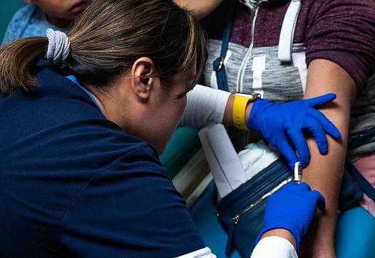 During a checkup in November 2019, Abraham and his mother, Magdalena Gonzalez, received a skin test from nurse Jackylou Cortez to evaluate how their bodies react to the fungus that causes valley fever. (Credit: UCLA)