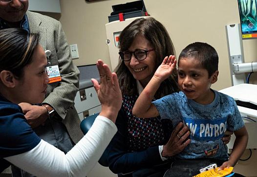 Six-year-old Abraham Gonzalez-Martinez celebrated a successful checkup at UCLA in November 2019 aloCortez, lefng with Dr. Manish Butte, back left, nurse Jackylout, and Dr. Maria Garcia-Lloret. (Credit: UCLA)