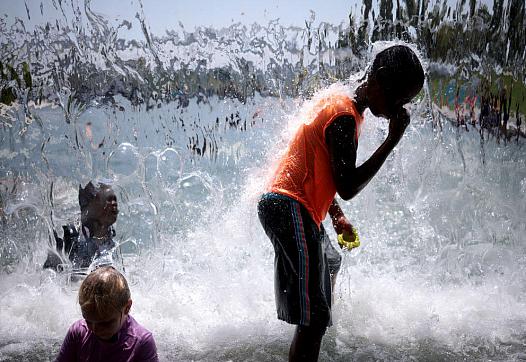 children standing close to flowing water