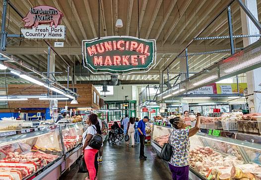 Large room with lit up market sign