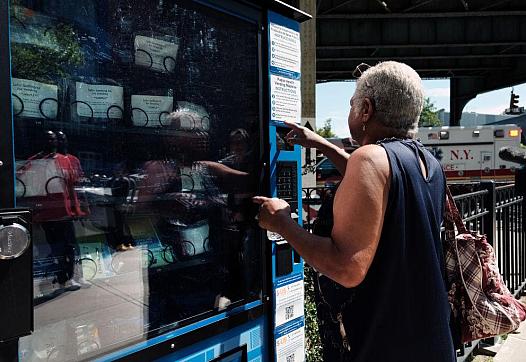 Person pressing a button o[n a vending machine