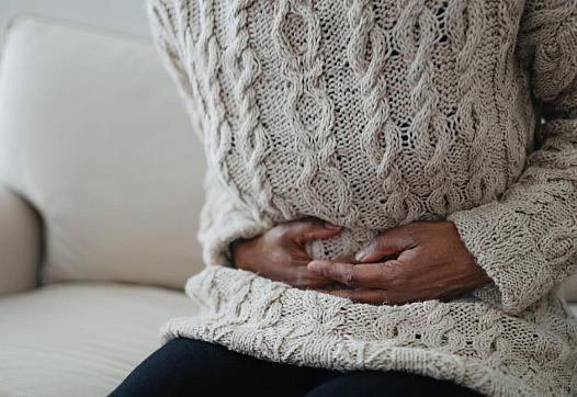 A person holding their stomach as if in pain