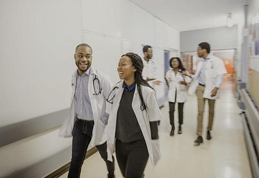 People in white coats walking