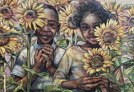 Wall mural of 2 children surrounded by sunflowers