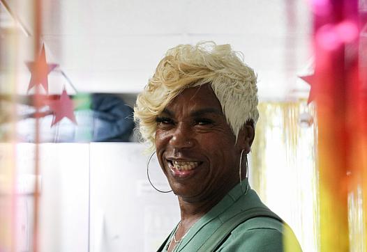 A person with golden hair and large earings