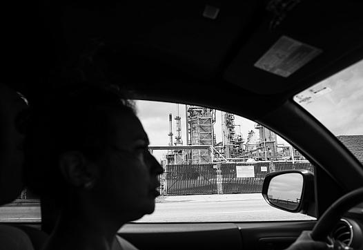 Jennifer Gomez drives past the Marathon refinery in Wilmington, California