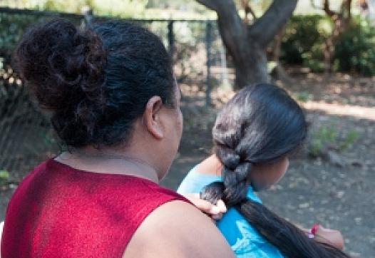 Victoria braids her daughter's hair after taking a shower at Hope's Corner. Photo by Ana Sofia Amieva-Wang