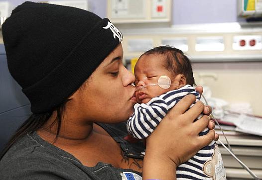 Alaina Gonville kisses her 3-month-old Brandon at the Neonatal Intensive Care Unit at Hutzel Women's Hospital in Detroit. Brandon was born premature through an emergency C-section. (Max Ortiz / The Detroit News)  
