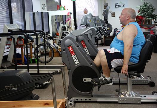 Ron Correll does physical therapy for his knee after ACL surgery, on a exercise bike at Dublin Physical Therapy on Dec. 18, 2014. (Jim Stevens/Bay Area News Group)