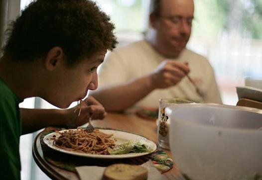Ryan Treece, 13, gobbles down dinner - as well as regular doses of junk food - but it doesn't seem to affect his weight. His twi