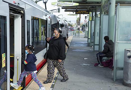 Passengers board a T-Third Street Muni train bound for Sunnydale at the Oakdale/Palou station in the Bayview District.