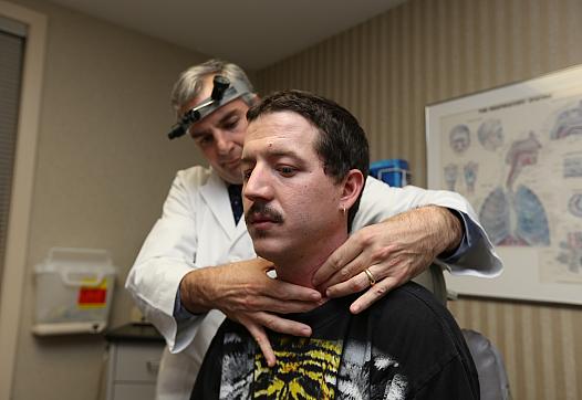 Raymond McElfers has his throat examined by his doctor. Photo: Emily Maxwell | WCPO