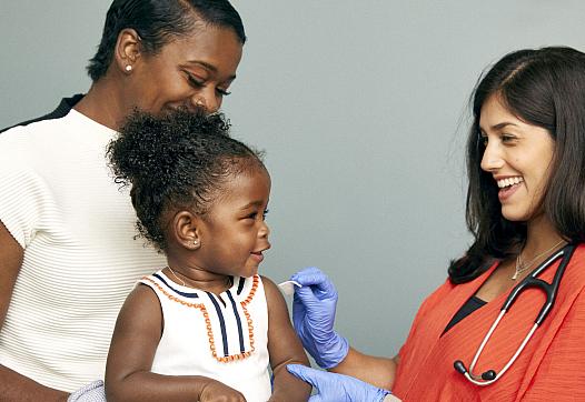 Toddler about to receive a vaccine from a doctor