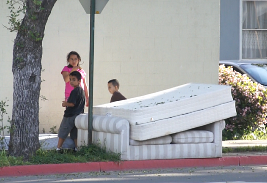 Children play on a street corner in central Santa Ana.