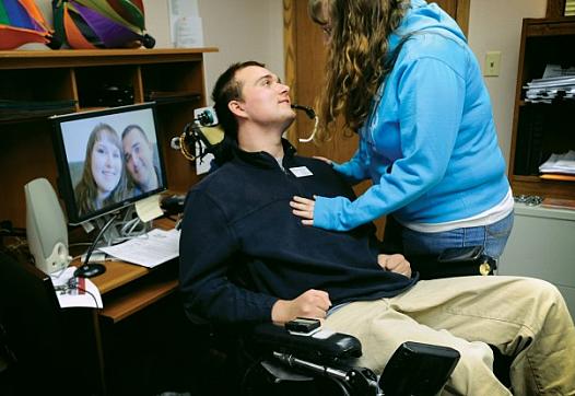 Michael Woods lost motor function in all of his limbs following a 2007 suicide attempt. He now travels to schools to speak on suicide prevention. He and his fiancee, Ashley Mead, spend a tender moment in his Billings office where he helps people with disabilities live independently. The couple plans to marry in June 2014.  