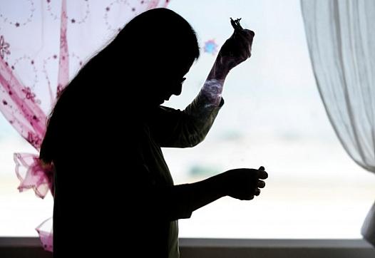 Jackie YellowTail smudges herself with cedar smoke in her home near Garryowen. YellowTail's 16-year-old son committed suicide in January 2001. She says her faith has pulled her through the tragedy. JAMES WOODCOCK/Gazette Staff