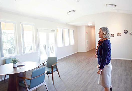 Elizabeth Wilson, director of housing development for MidPen Housing, looks over a common area of the new Van Buren apartment co