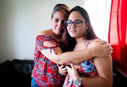 Karoline Vázquez Díaz and her mother, Brenda Diaz embrace in their home in Morovis.