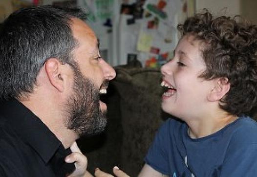 Michael Ashline, left, and his son Andrew, a special needs student in Orange, at their home in 2014.