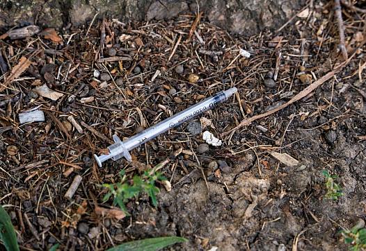 A used needle on the ground in Garfield Park in an area known for heroin use.