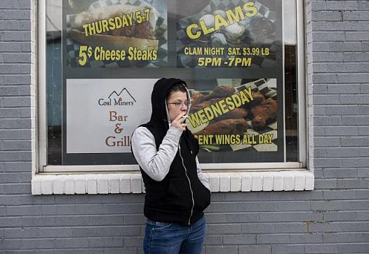 Alicia Kachmar takes a puff from her cigarette outside of Coal Miners Bar & Grill. (Photo: Rick Kintze/The Morning Call)