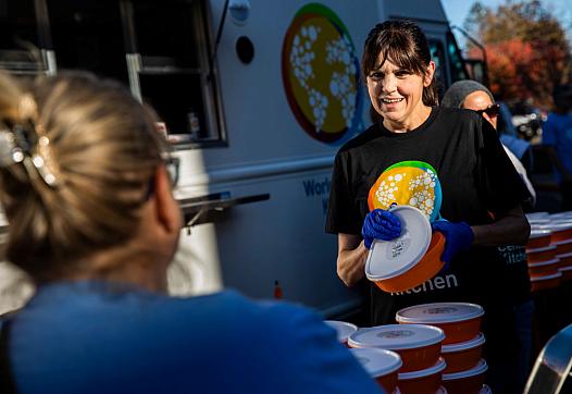 A volunteer serves food during a community meal event for the one-year anniversary of the November 2018 Camp Fire.