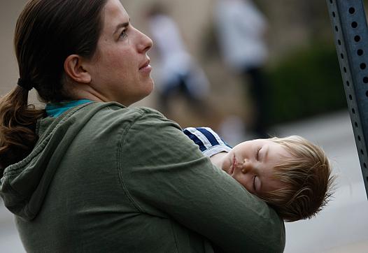 An uninsured mother and her son wait at a free health clinic in Inglewood, California.