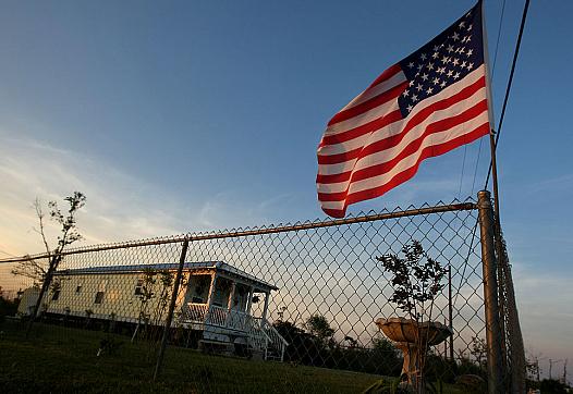 An American flag flies above a post-Katrina trailer in Waveland, Mississippi. 