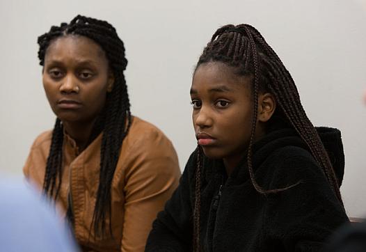Connie White, left, and her daughter, Lataevia Gaskin, listen during a Restorative Justice Louisville meeting in January 2018. (