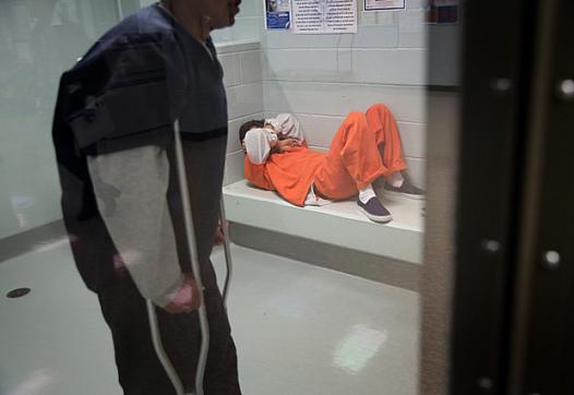 Immigrants wait in a processing cell at the Adelanto Detention Facility in Adelanto, California. (Photo: John Moore/Getty Images