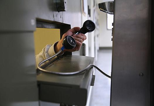 An immigrant makes a call from a cell at the Adelanto Detention Facility in Adelanto, California.